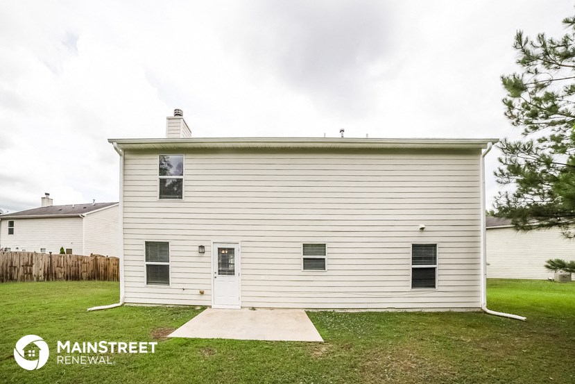 the view of a small white house with a white garage door