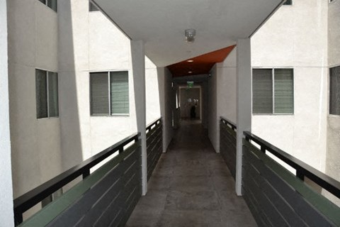 A long hallway with a person standing at the end.