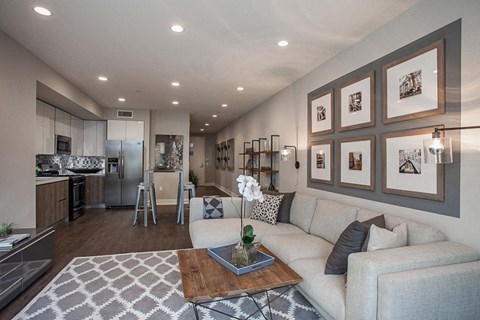 A modern living room with a grey couch and a coffee table.
