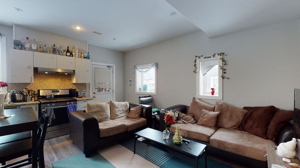 a living room with a couch and a table and a kitchen