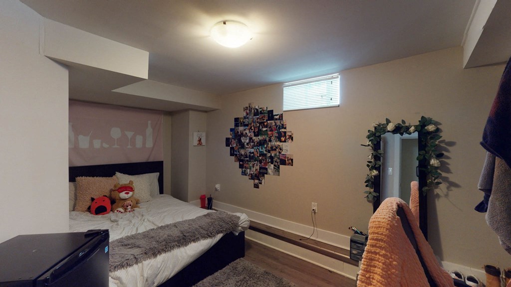 a bedroom with a bed and a dresser