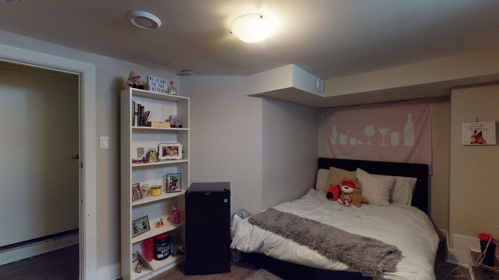 a bedroom with a bed and a book shelf