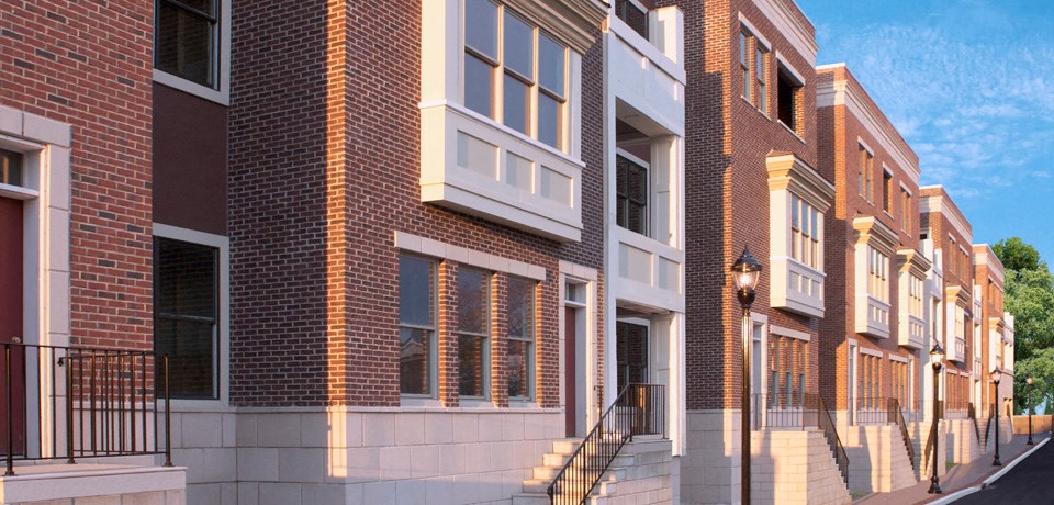 a rendering of a row of town houses on a city street