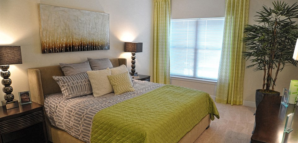a bedroom with a bed and a painting on the wall