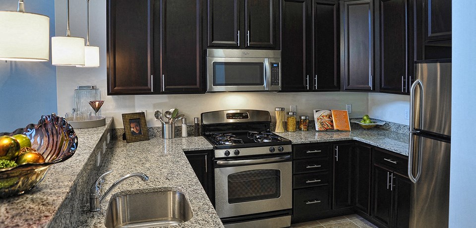 a kitchen with stainless steel appliances and granite counter tops