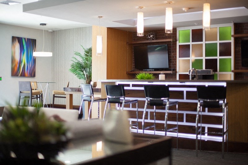 a living room with a bar and a television