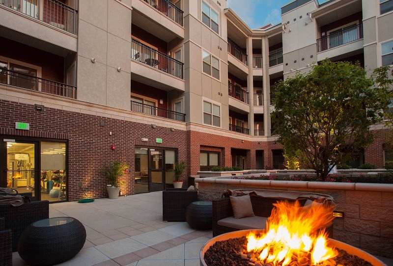 a fire pit in front of an apartment building