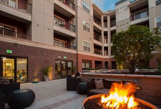 a fire pit in the courtyard of an apartment building