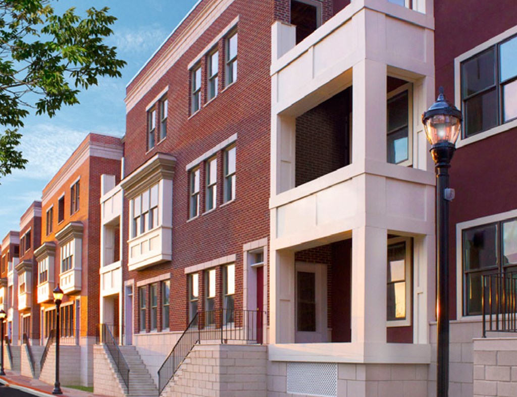 a row of brick apartment buildings on a city street