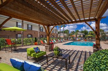 large pergola with lounge furniture by pool at The Mills at 601, Prattville, Alabama