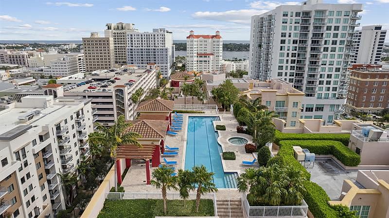 A view of a pool area with a red roof and a blue pool.