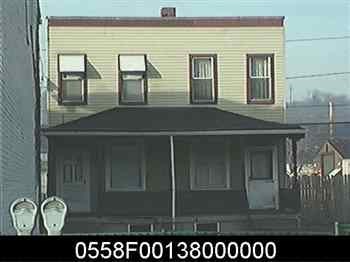 a picture of a yellow house with a black roof