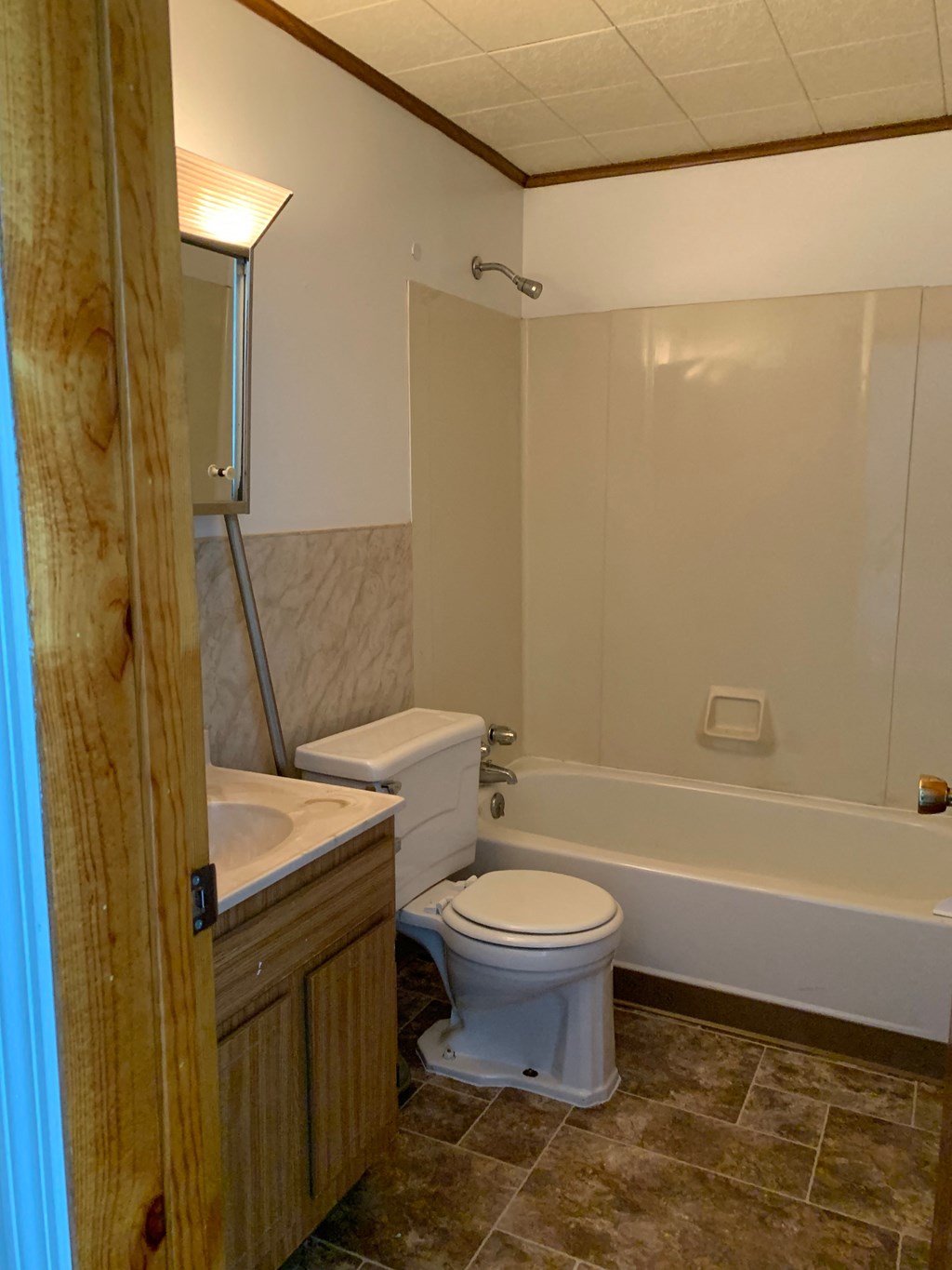 A white toilet is next to a sink in a bathroom.