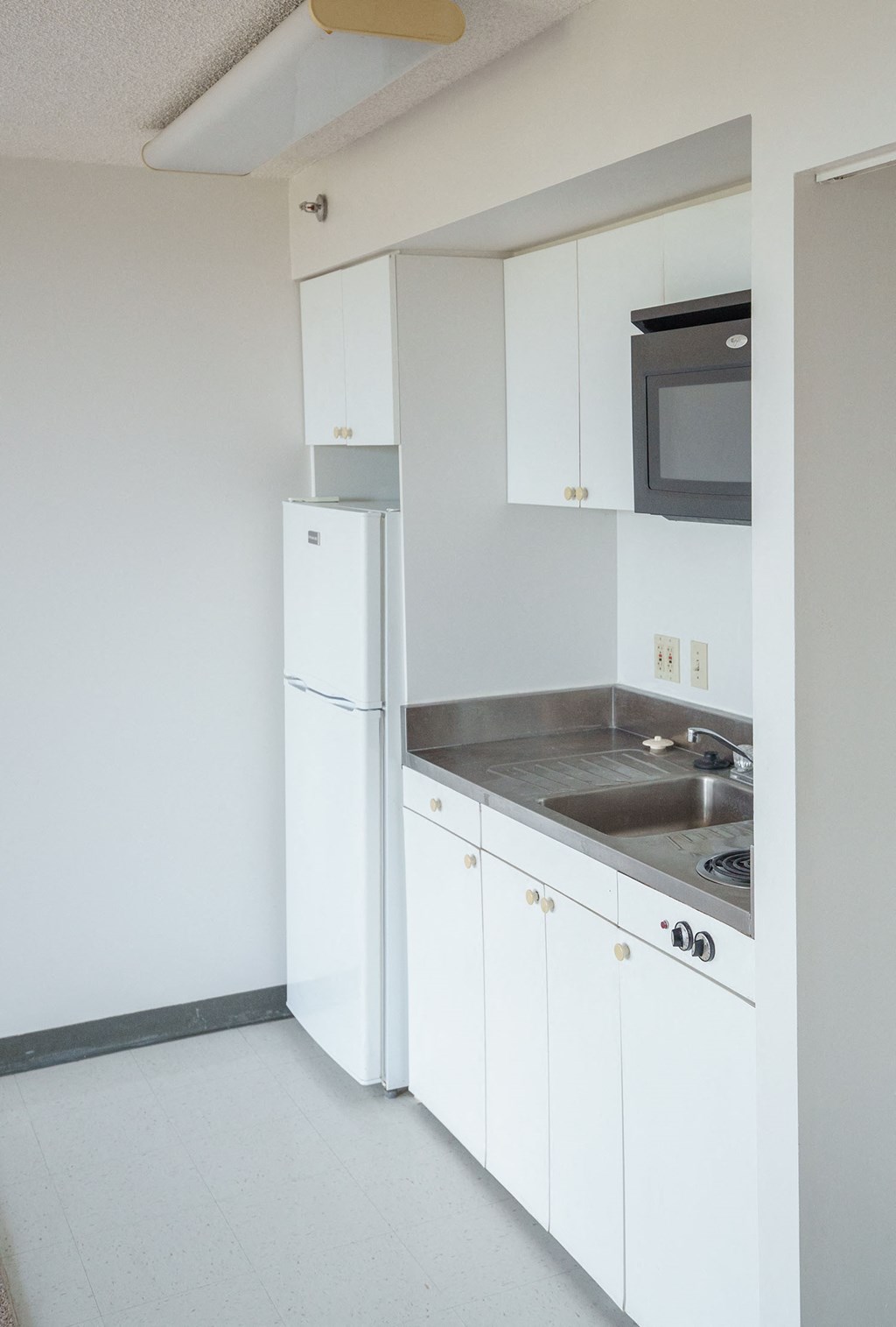 Kitchen with white cabinets and appliances