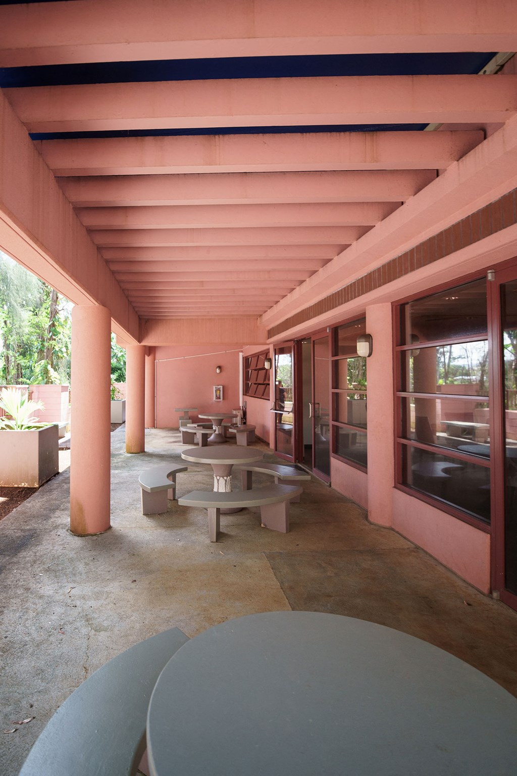 Patio with three circular tables and benches