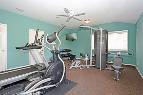 Fitness center with treadmill, weights and tv