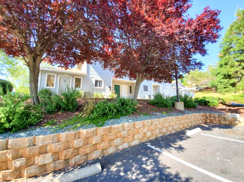 Parking lot and exterior view of building at Cameron Park Village Apartments, Cameron Park