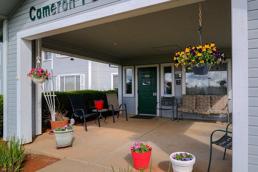 Patio with seating outside front of leasing office at Cameron Park Village Apartments, California