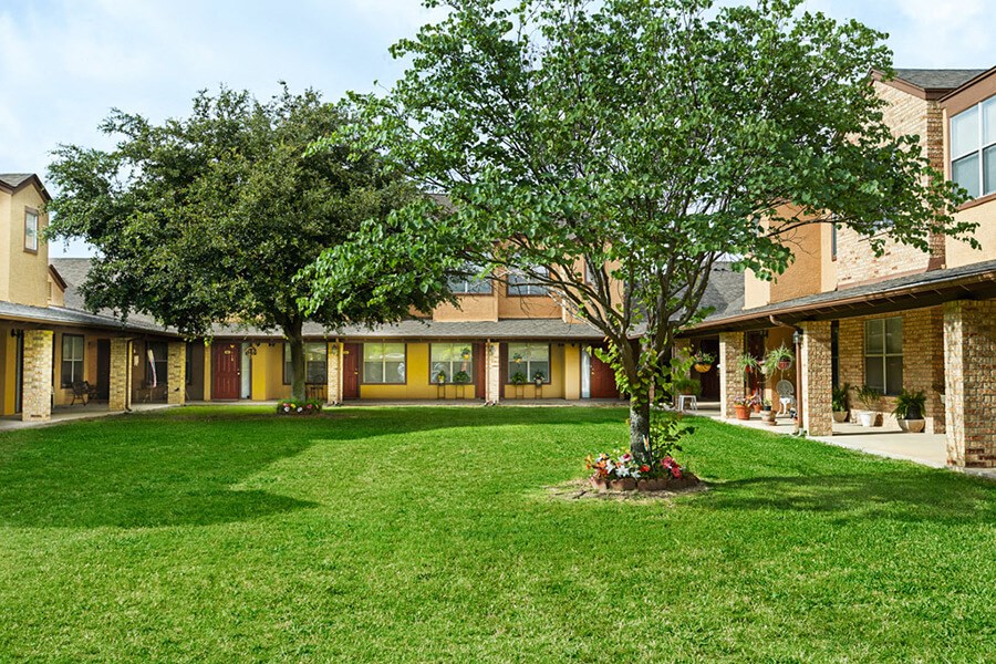 Large grass courtyard between buildings