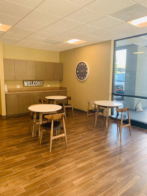 Community room with tables and chairs at 7251 at Waters Edge, Chicago, IL