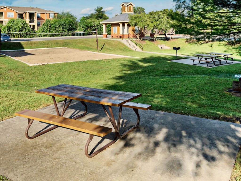 Volleyball court surrounded by picnic tables