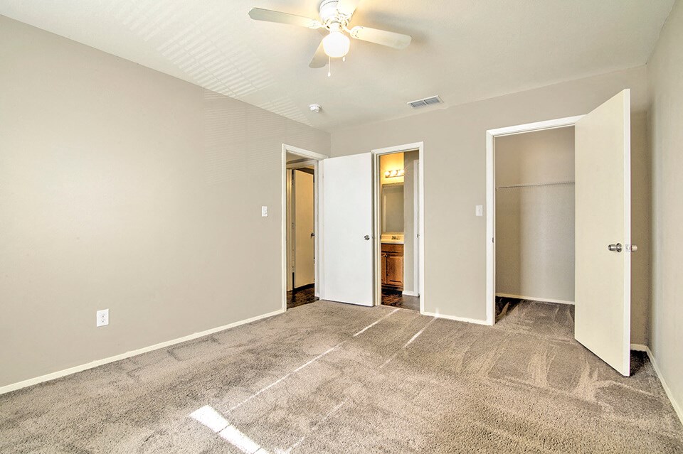 Bedroom with attached bathroom and closets
