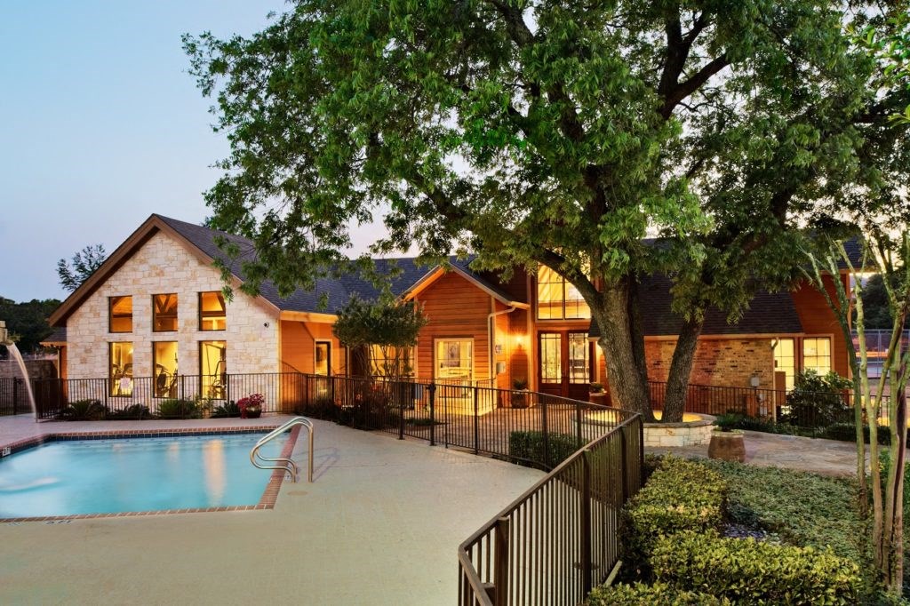 pool and exterior clubhouse at sunset