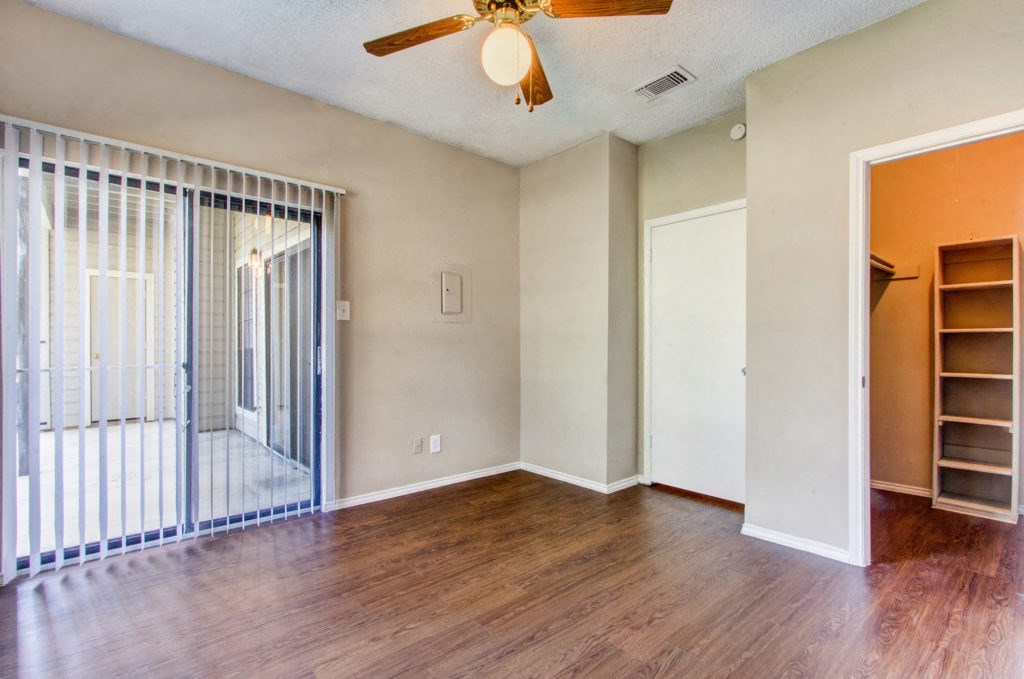 Living room with patio door and ceiling fan