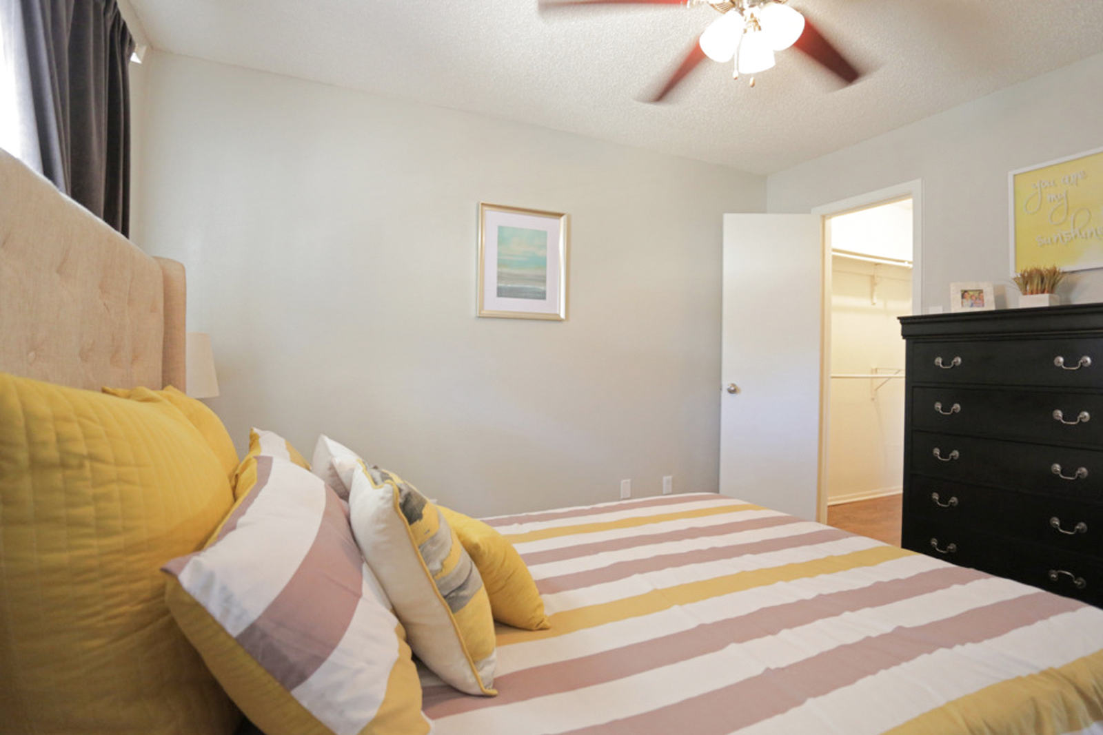 Furnished bedroom with ceiling fan