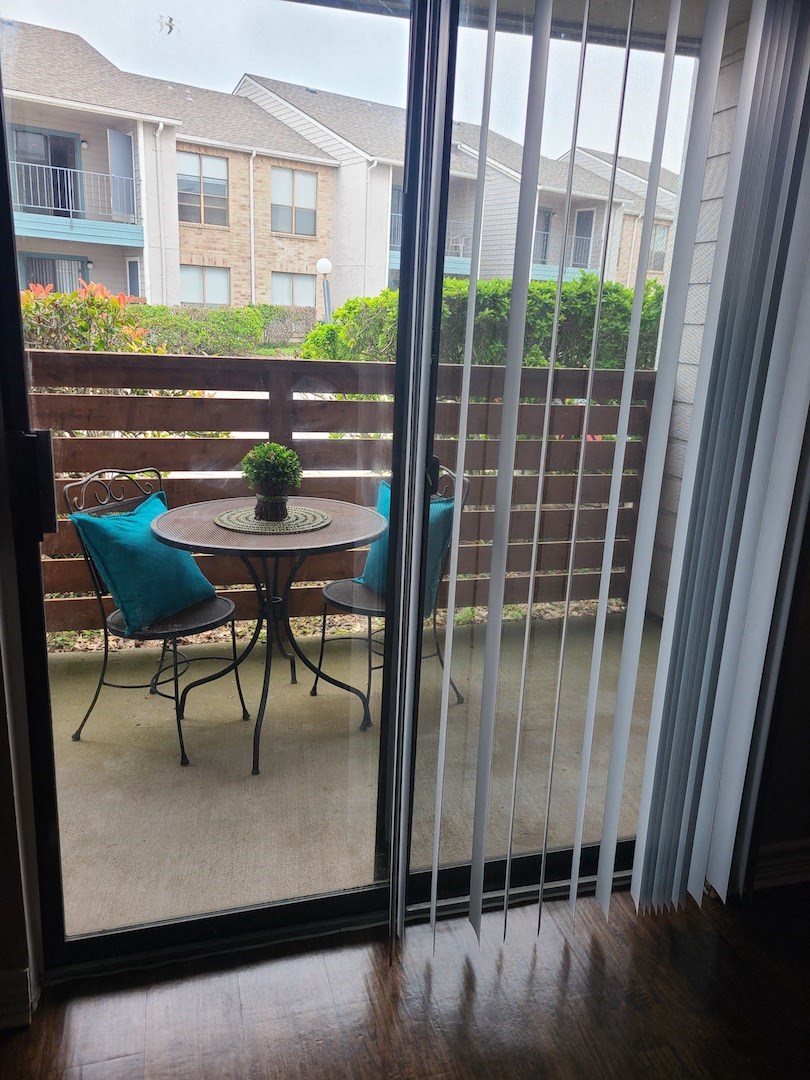 Sliding glass door leading to patio at Sugar Tree Apartment Homes, Corpus Christi