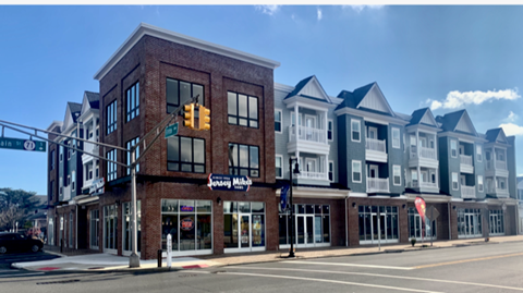 a rendering of a building on the corner of a city street