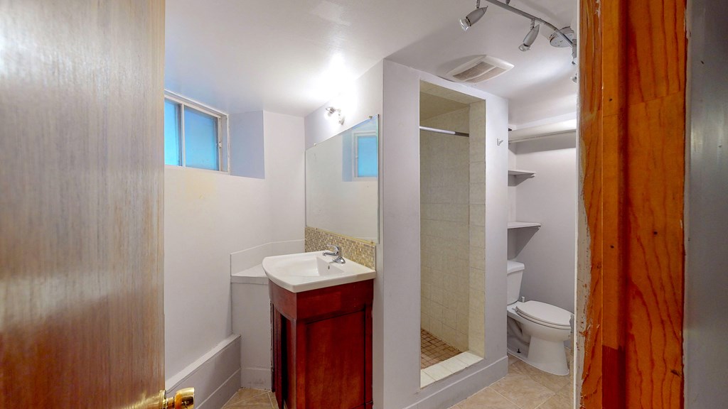 a bathroom with a sink toilet and a shower