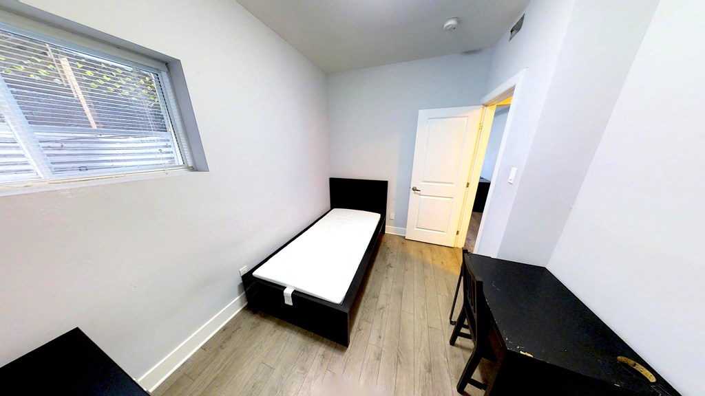 an empty room with a bed and a table