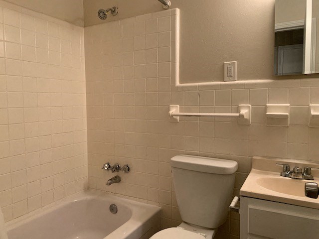 a bathroom with a toilet and a sink and a bath tub