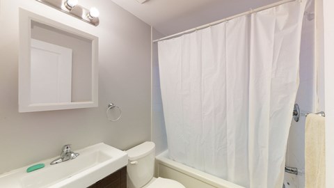 a bathroom with a shower and a sink and a toilet