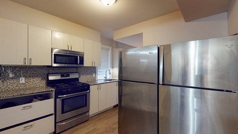 full kitchen with stainless steel appliances and granite counter tops