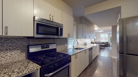 full kitchen with granite counter tops and stainless steel appliances