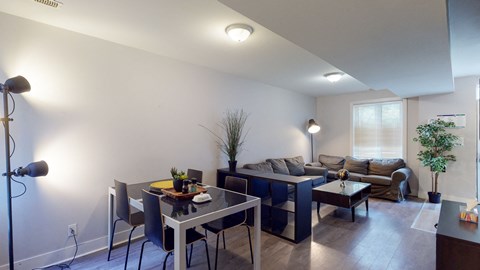 a living room and dining room with a couch and a table