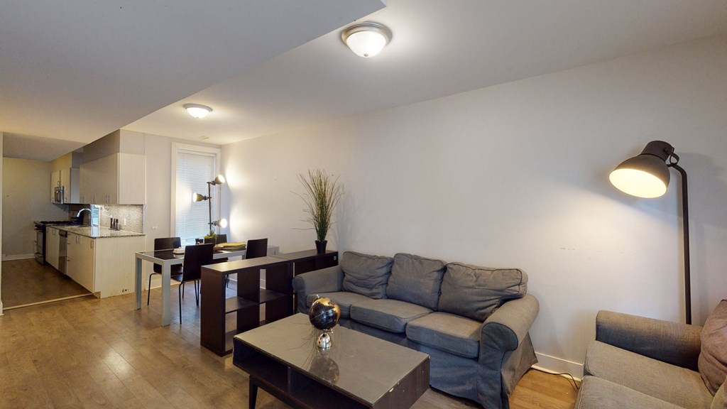 a living room and dining room with a couch and a table