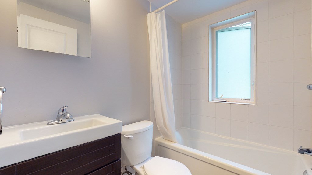 a bathroom with a sink toilet and a bath tub