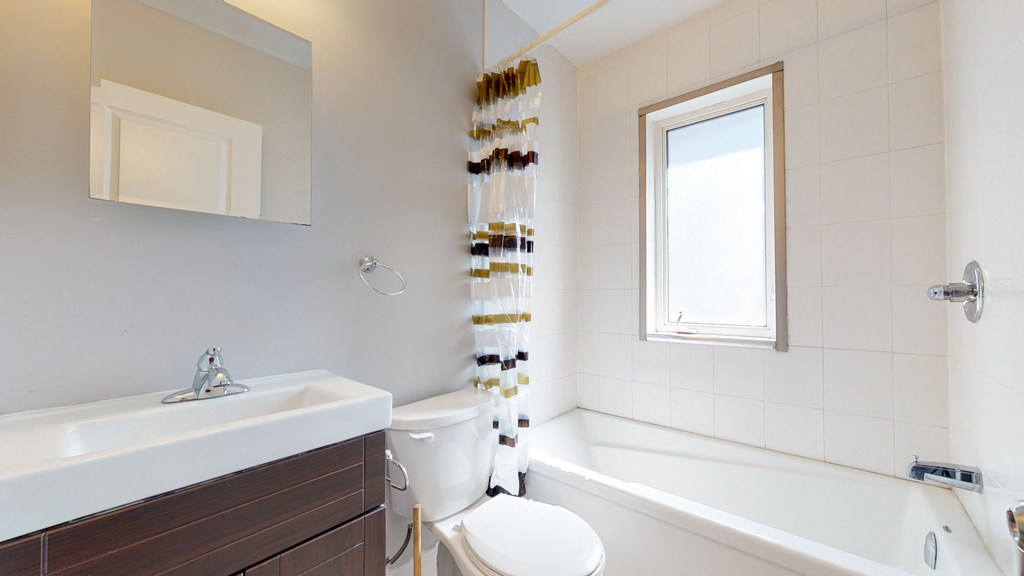 a bathroom with a sink toilet and a tub
