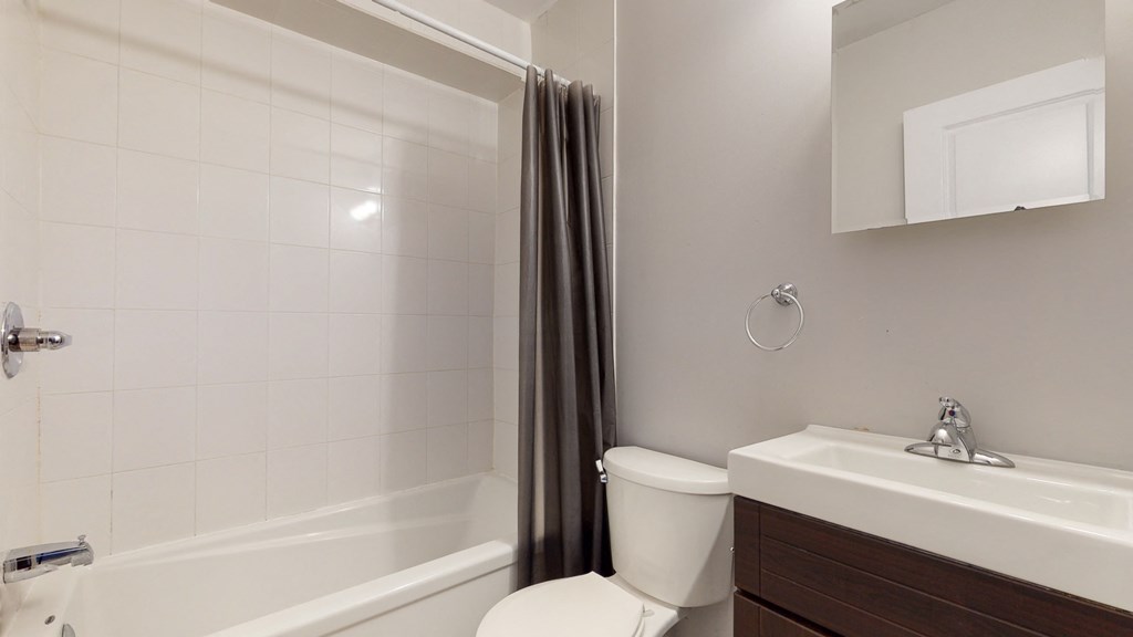 an empty bathroom with a toilet sink and shower