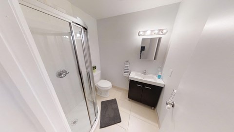 a bathroom with a shower and a sink and a toilet