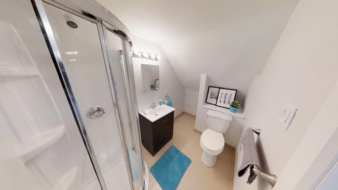 a bathroom with a shower and a toilet and a sink