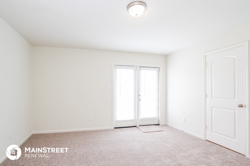 the interior of an empty room with white walls and white doors