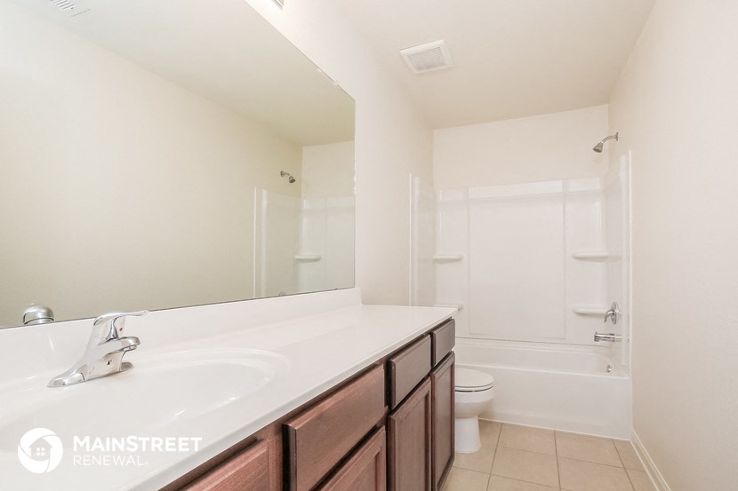 a bathroom with a sink and a shower and a toilet