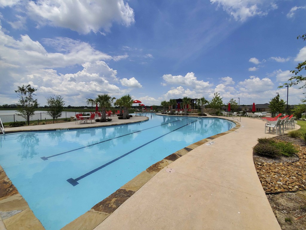 a large pool of water at a resort with a cloudy sky