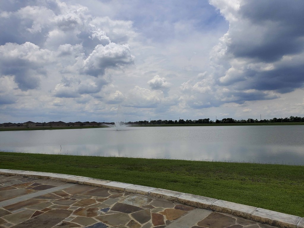 a large body of water with clouds in the sky