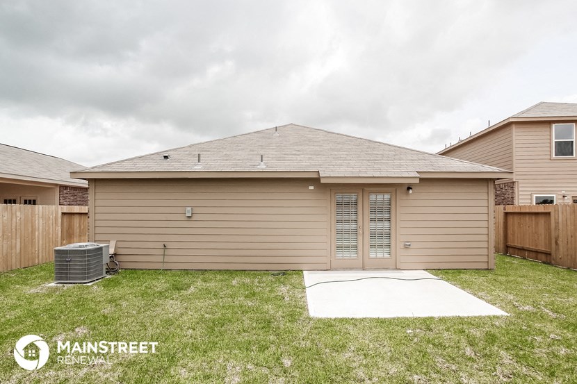 the exterior of a home with a yard and a garage
