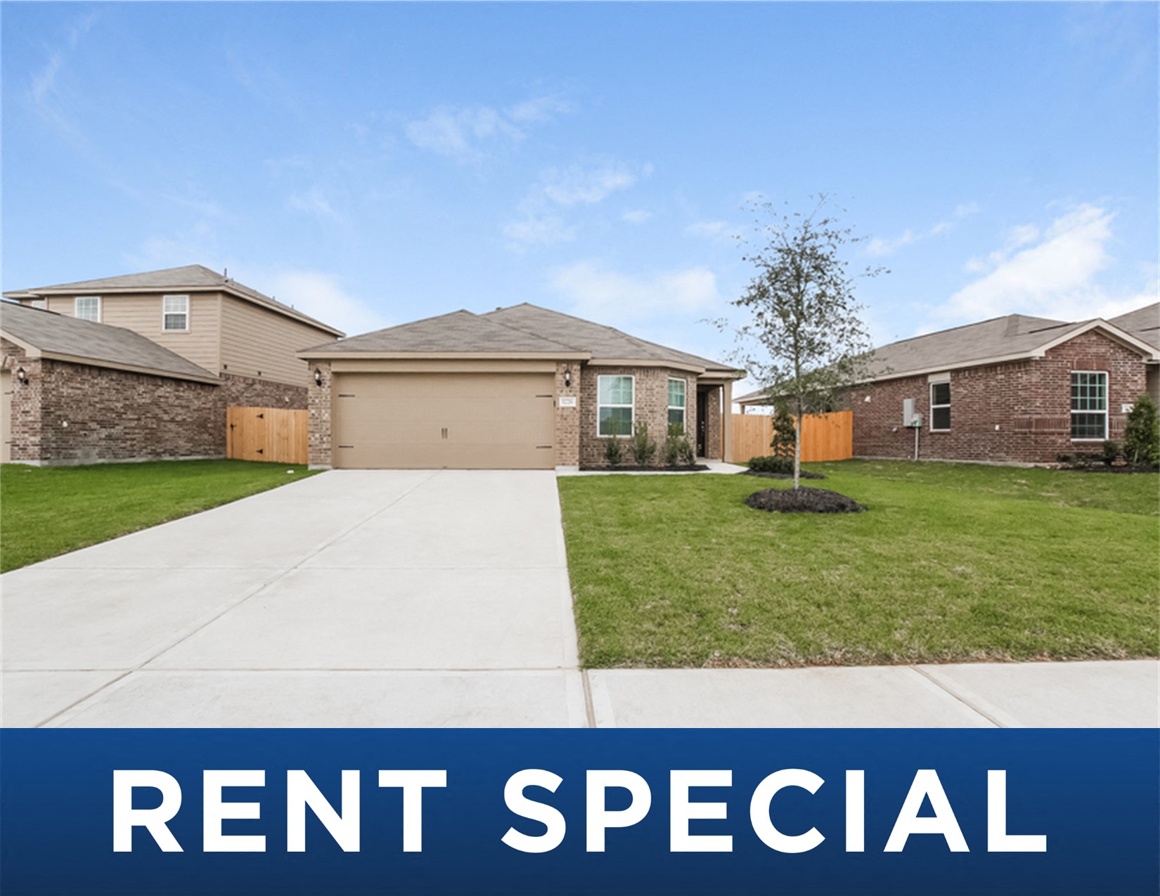 a house with a yard and a driveway and the rent special sign